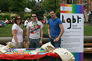 Photo of three people hosting The University of Sheffield LGBT+ Staff Network stall at Pinknic.
